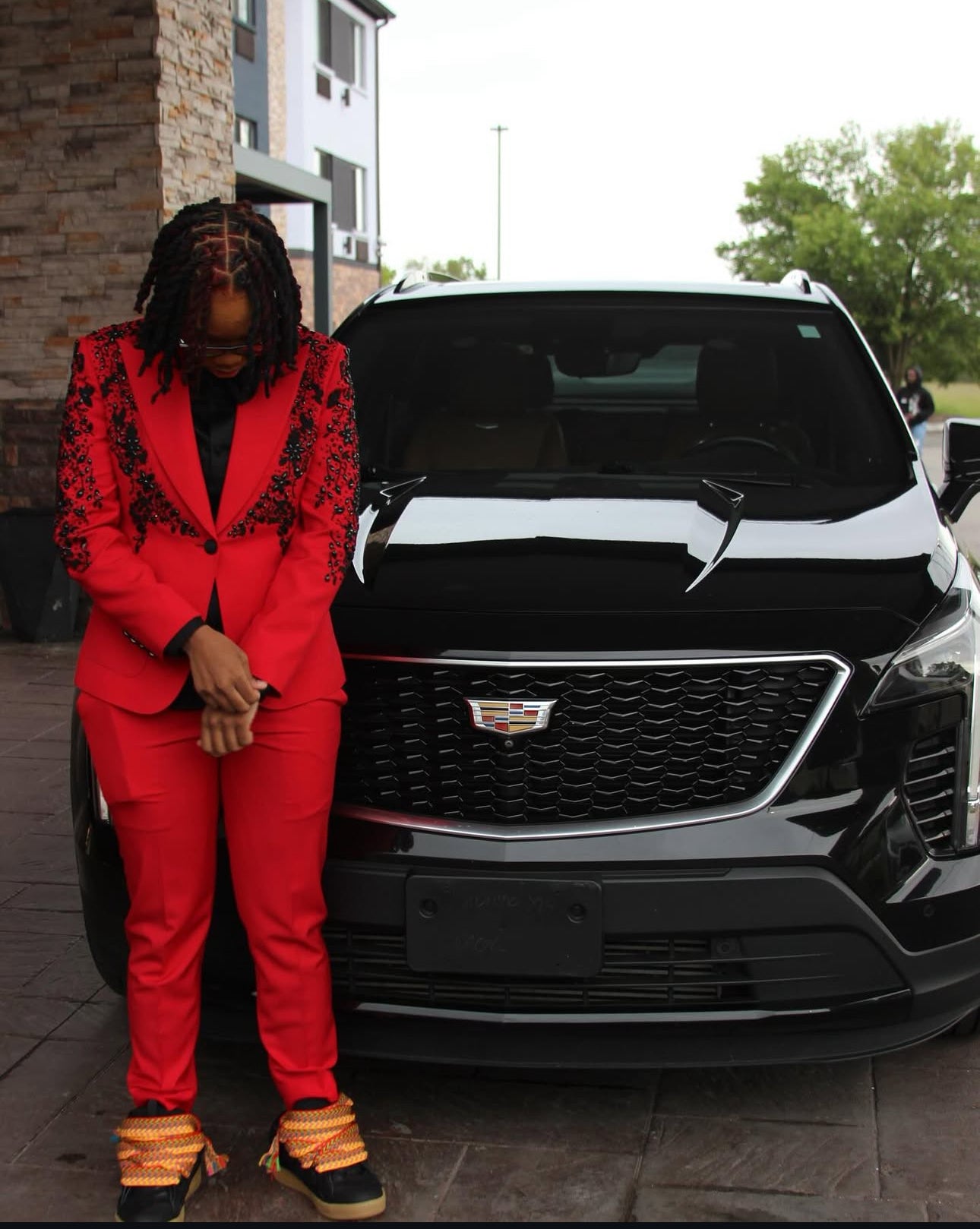 Red Women's suit with black embellishments