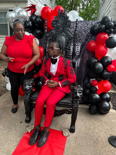 Red suit with black cross and black embellishments