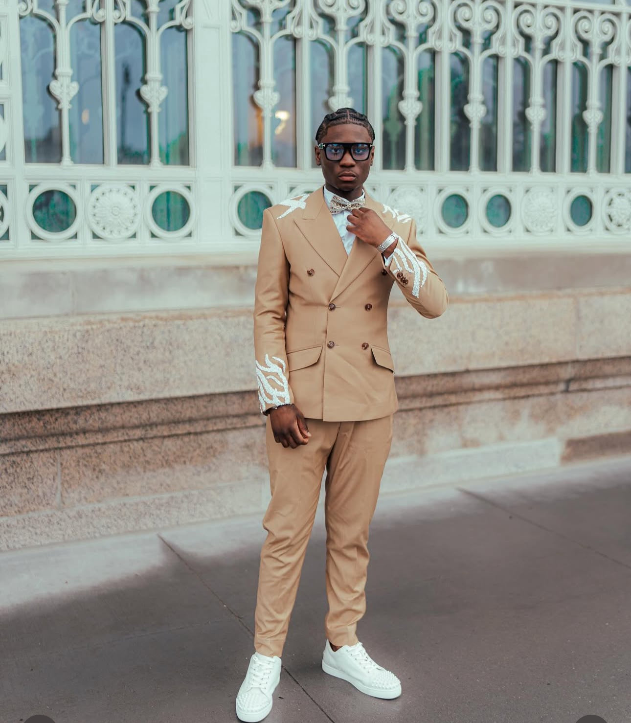 Tan suit with white embellishments