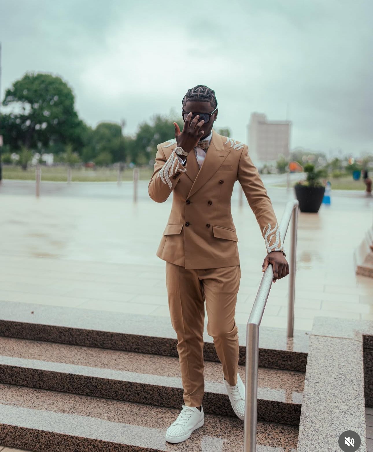 Tan suit with white embellishments