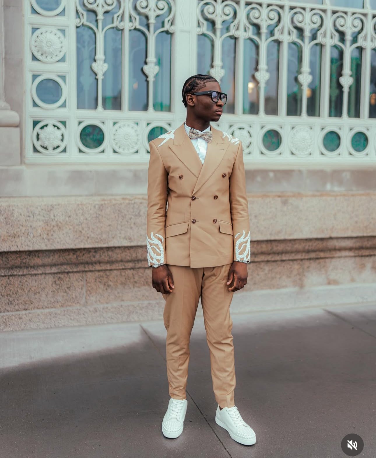 Tan suit with white embellishments