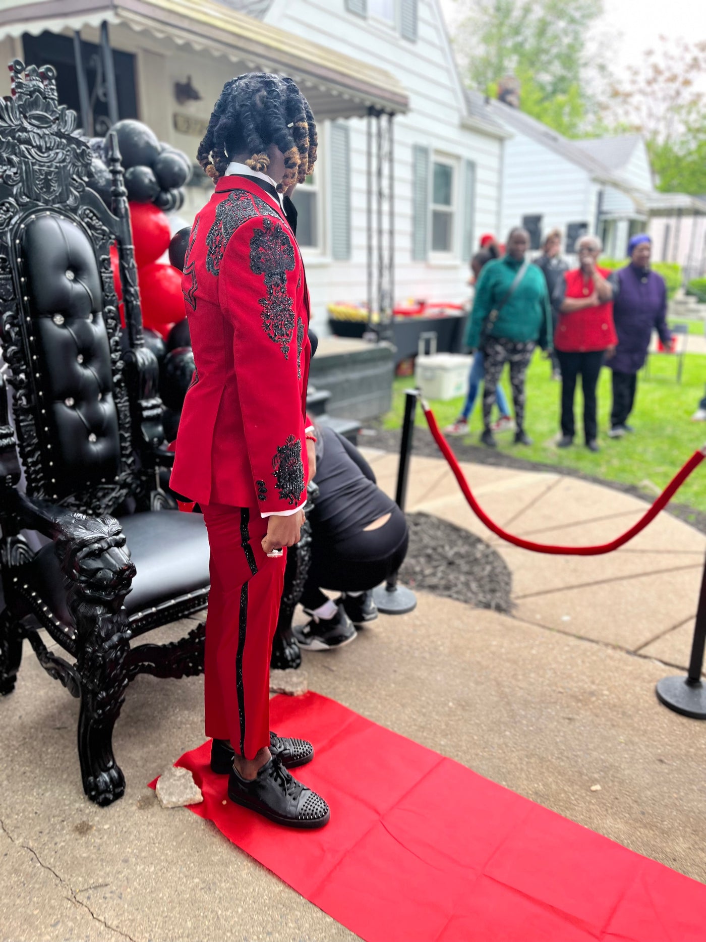 Red suit with black cross and black embellishments