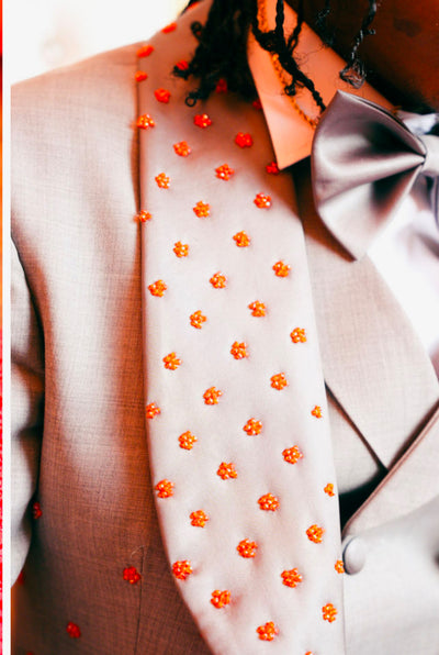 Grey suit with orange embellishments